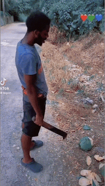 A Man In A Blue Shirt Is Holding A Large Axe In His Hand GIF