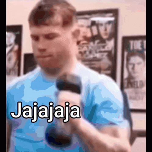 A Man In A Blue Shirt Is Holding A Microphone And Says Jajajaja GIF