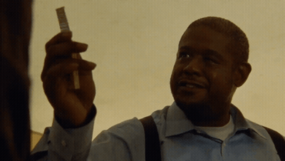 A Man In A Blue Shirt Is Holding A Piece Of Paper In His Hand GIF