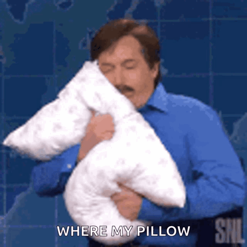 A Man In A Blue Shirt Is Holding A Pillow In His Hands And Saying `` Where My Pillow '' . GIF