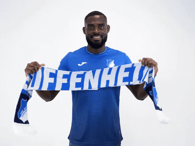 A Man In A Blue Shirt Is Holding A Scarf That Says Affenheid GIF