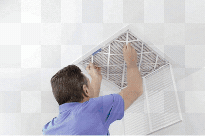 A Man In A Blue Shirt Is Installing A Filter GIF