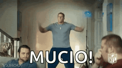 A Man In A Blue Shirt Is Jumping In The Air With The Word Mucio In Front Of Him . GIF