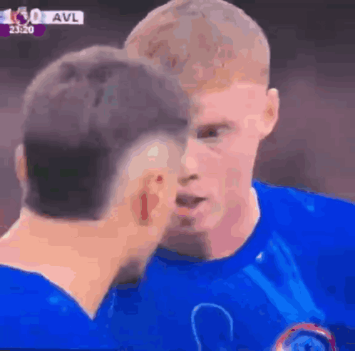A Man In A Blue Shirt Is Kissing Another Man 'S Cheek GIF