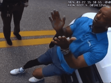 A Man In A Blue Shirt Is Kneeling Down With His Hands Up GIF
