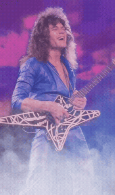 A Man In A Blue Shirt Is Playing A Guitar With A Star Design On It GIF