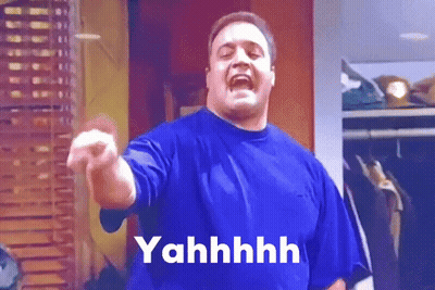 A Man In A Blue Shirt Is Pointing At The Camera And The Word Yahhhh Is On The Bottom GIF