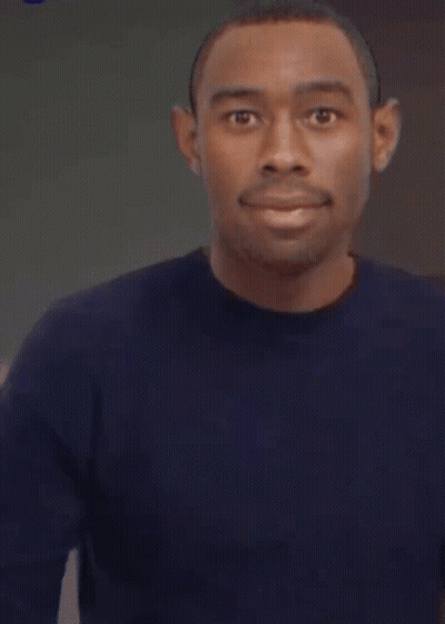 A Man In A Blue Shirt Is Pointing His Finger GIF