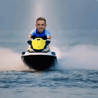 A Man In A Blue Shirt Is Riding A Jet Ski GIF