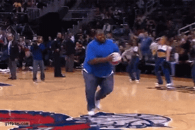 A Man In A Blue Shirt Is Running On A Basketball Court Holding A Basketball . GIF