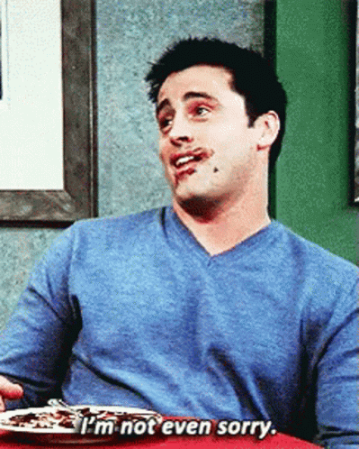 A Man In A Blue Shirt Is Sitting At A Table With A Plate Of Food And Says I 'M Not Even Sorry GIF