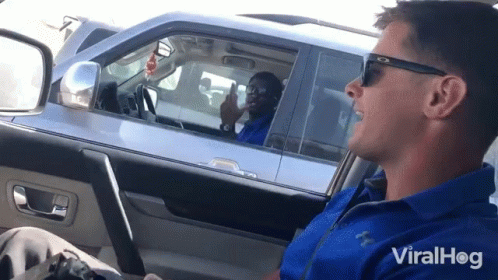 A Man In A Blue Shirt Is Sitting In A Car With Viralhog Written On The Bottom Right GIF