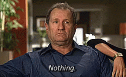 A Man In A Blue Shirt Is Sitting In A Chair And Says Nothing GIF