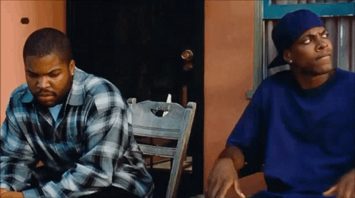 A Man In A Blue Shirt Is Sitting Next To Another Man In A Blue Hat GIF