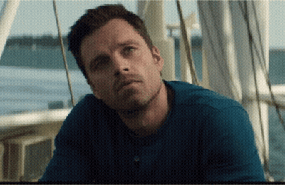 A Man In A Blue Shirt Is Sitting On A Boat Near The Water GIF