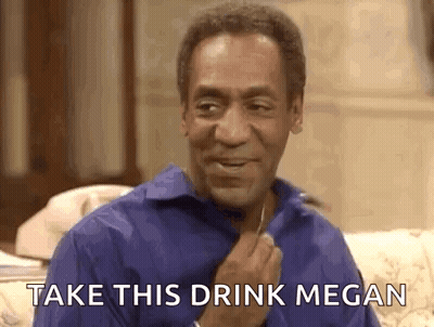 A Man In A Blue Shirt Is Sitting On A Couch With The Words `` Take This Drink Megan '' Written On It . GIF