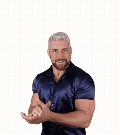 A Man In A Blue Shirt Is Smiling And Making A Funny Face GIF