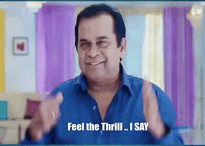 A Man In A Blue Shirt Is Smiling And Saying `` Feel The Thrill , I Say '' . GIF