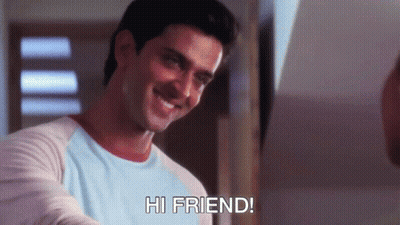 A Man In A Blue Shirt Is Smiling And Says Hi Friend GIF