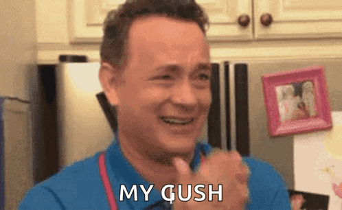A Man In A Blue Shirt Is Smiling And Says My Gush GIF