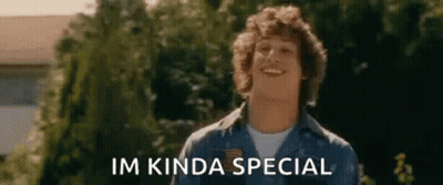 A Man In A Blue Shirt Is Smiling In Front Of Trees And The Words `` Im Kinda Special '' . GIF