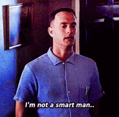 A Man In A Blue Shirt Is Standing In A Dark Room And Says I 'M Not A Smart Man . GIF