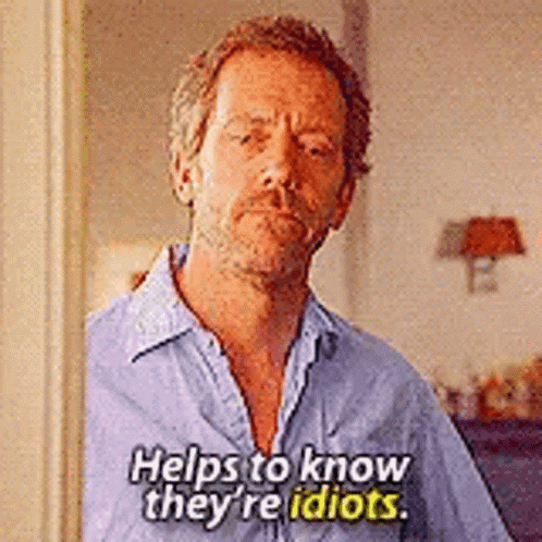 A Man In A Blue Shirt Is Standing In A Doorway And Says `` Helps To Know They 'Re Idiots . '' GIF