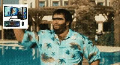 A Man In A Blue Shirt Is Standing In Front Of A Computer Monitor Keyboard And Mouse GIF