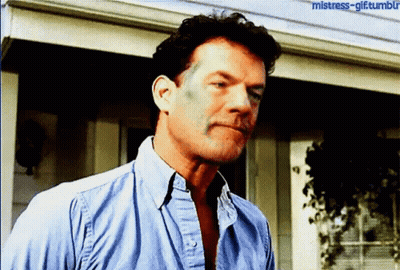 A Man In A Blue Shirt Is Standing In Front Of A House With The Words Mistress-Gif Tumblr Written On The Bottom GIF