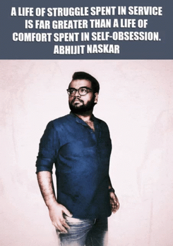 A Man In A Blue Shirt Is Standing In Front Of A Quote From Abhijit Naskar GIF