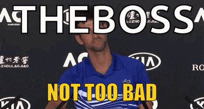 A Man In A Blue Shirt Is Standing In Front Of A Sign That Says " At The Boss " GIF