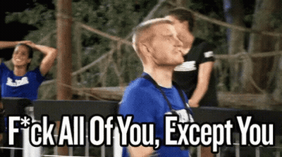 A Man In A Blue Shirt Is Standing In Front Of A Sign That Says " Fuck All Of You Except You " GIF