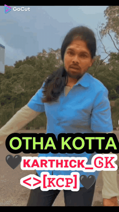 A Man In A Blue Shirt Is Standing In Front Of A Sign That Says Otha Kotta Karthick Gk Kcp GIF