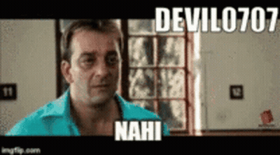 A Man In A Blue Shirt Is Standing In Front Of A Window And A Sign That Says Devil0707 Nahi . GIF