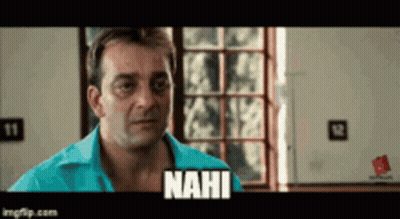 A Man In A Blue Shirt Is Standing In Front Of A Window And Says Nahi GIF
