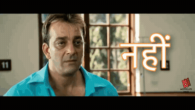 A Man In A Blue Shirt Is Standing In Front Of A Window With The Number 11 On The Wall Behind Him GIF