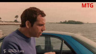 A Man In A Blue Shirt Is Standing Next To A Blue Car That Says Fandango Movieclips GIF