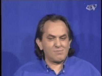 A Man In A Blue Shirt Is Standing Next To A Man In A White Shirt In Front Of A Cer Water Cooler GIF
