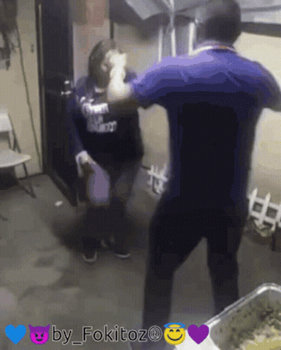 A Man In A Blue Shirt Is Standing Next To A Woman In A Black Shirt That Says ' I Love You ' On It GIF