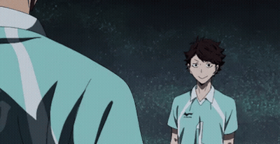A Man In A Blue Shirt Is Standing Next To Another Man In A Blue Shirt . GIF