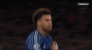 A Man In A Blue Shirt Is Standing Next To Another Man . GIF