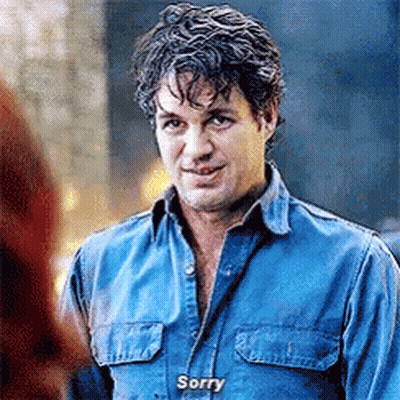 A Man In A Blue Shirt Is Talking To A Woman And Says `` Sorry '' . GIF