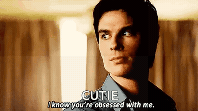 A Man In A Blue Shirt Is Talking To Another Man . GIF