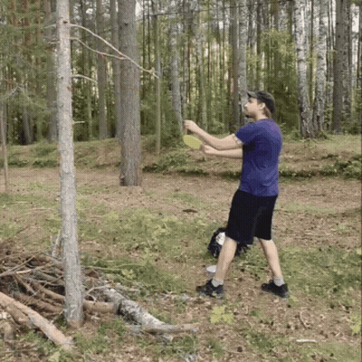 A Man In A Blue Shirt Is Throwing A Frisbee GIF
