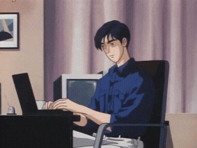 A Man In A Blue Shirt Is Typing On A Black Laptop GIF