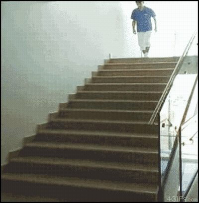 A Man In A Blue Shirt Is Walking Up A Set Of Stairs With 4Gifs.com In The Corner GIF