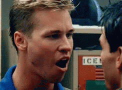 A Man In A Blue Shirt Is Yelling At Another Man In Front Of A Locker With The Word Ice On It GIF