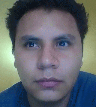 Man In Blue Shirt Looking At Camera GIF