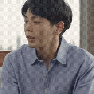 A Man In A Blue Shirt Looks To His Left GIF