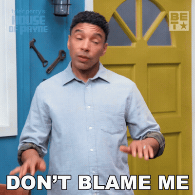 A Man In A Blue Shirt Says " Do N't Blame Me " In Front Of A Yellow Door GIF